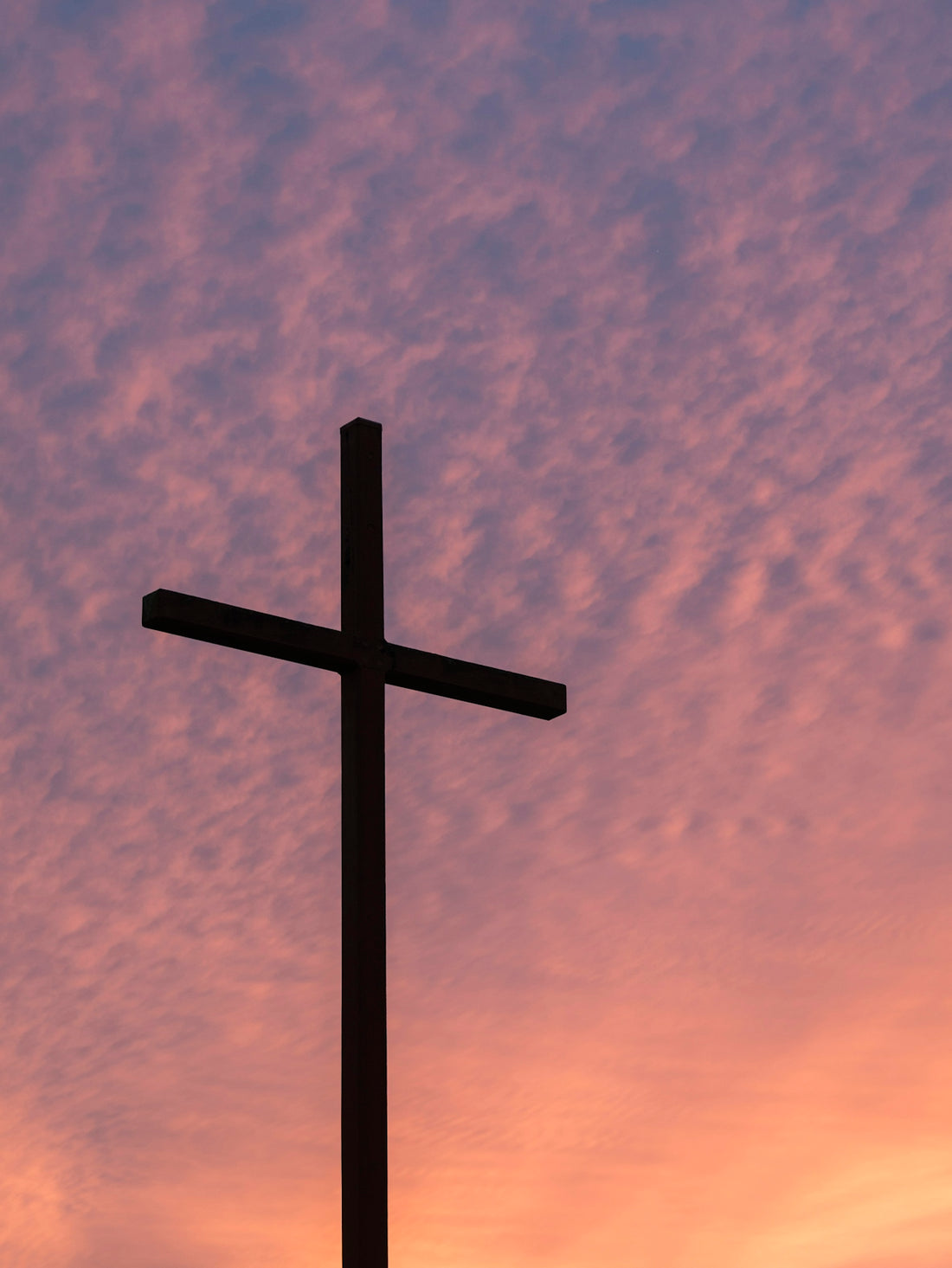 silhouette of large cross during daytime