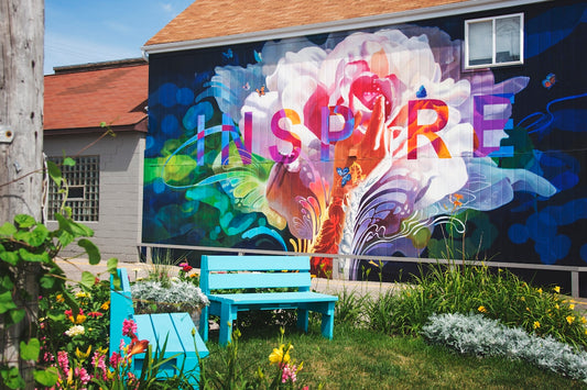 blue wooden bench near wall with graffiti