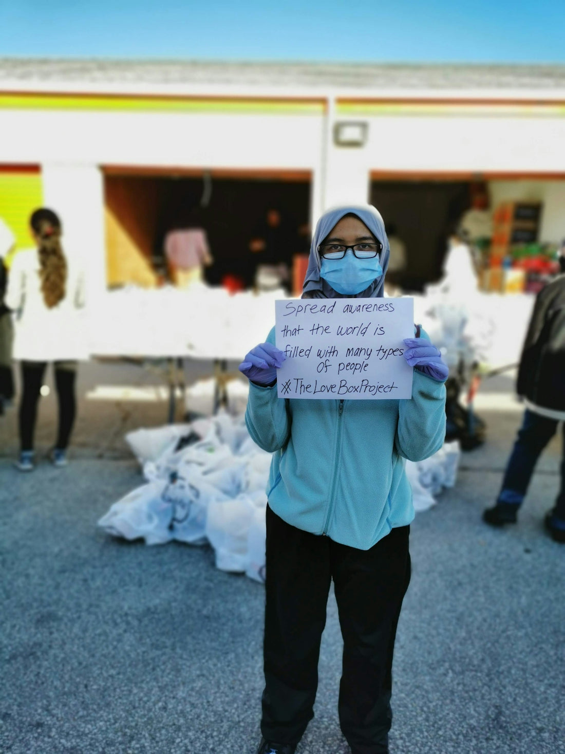woman in blue jacket and black pants wearing white goggles