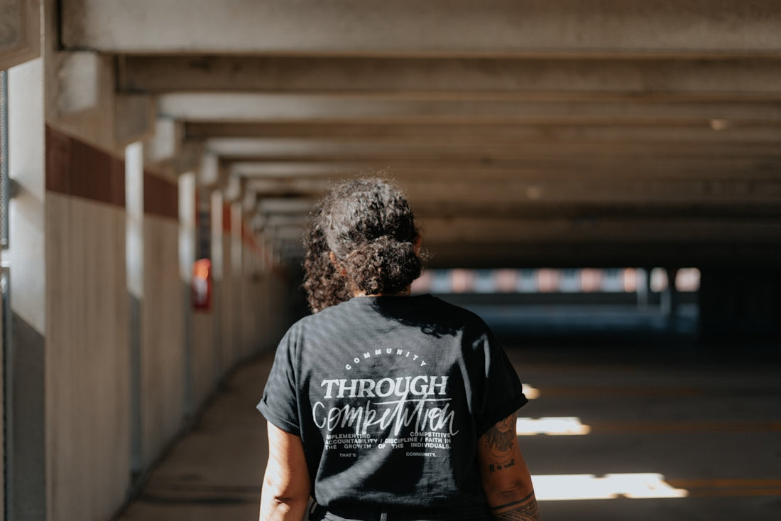 man in black crew neck t-shirt standing on sidewalk during daytime