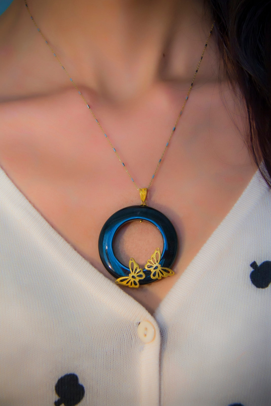 woman wearing blue and silver necklace