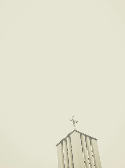 a church steeple with a cross on top