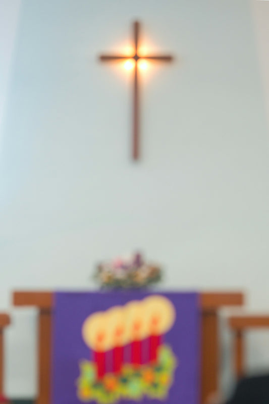 a blurry photo of a cross in the background