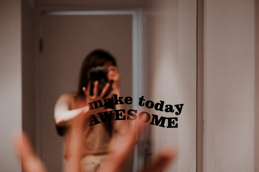 a person taking a picture of themselves in a mirror