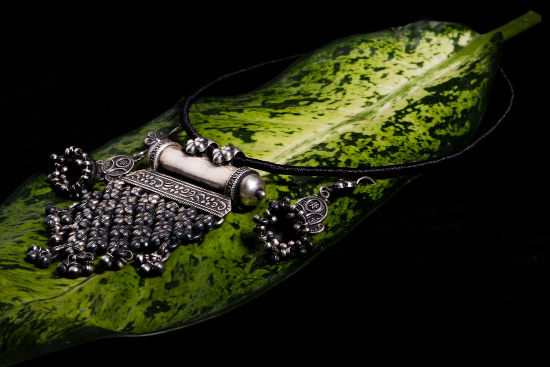 a green leaf with a necklace on it