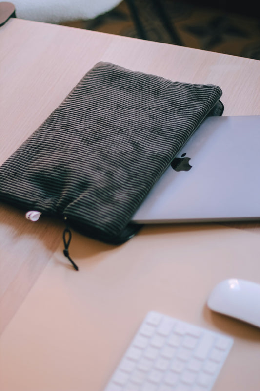 a laptop computer sitting on top of a wooden desk