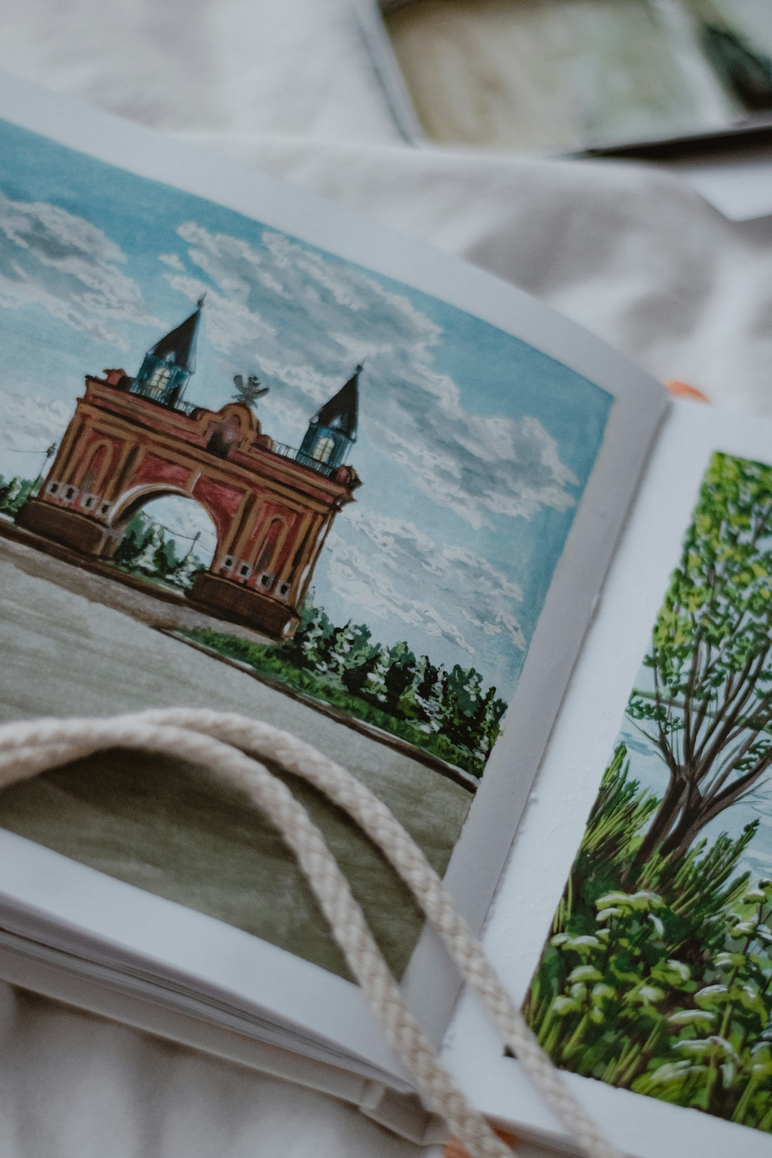 Watercolor paintings of a building and trees.