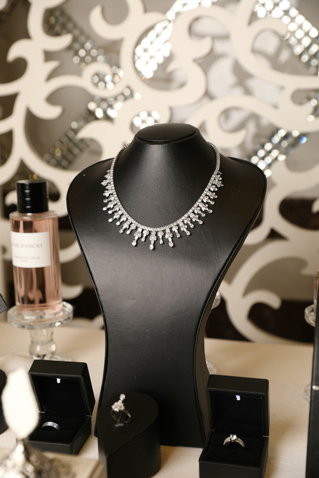 A diamond necklace displays elegantly on a mannequin.