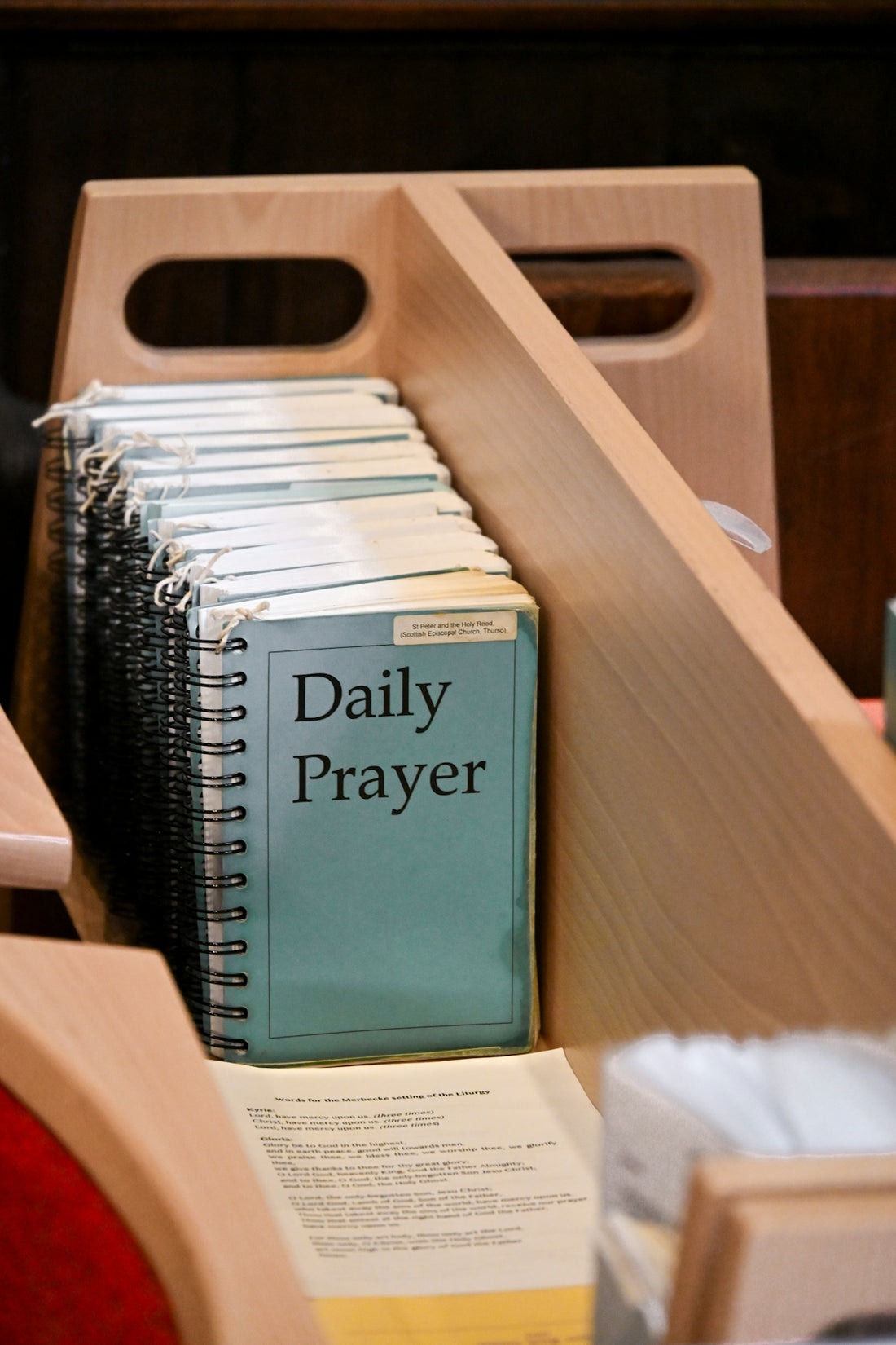 Daily prayer books in a wooden holder.