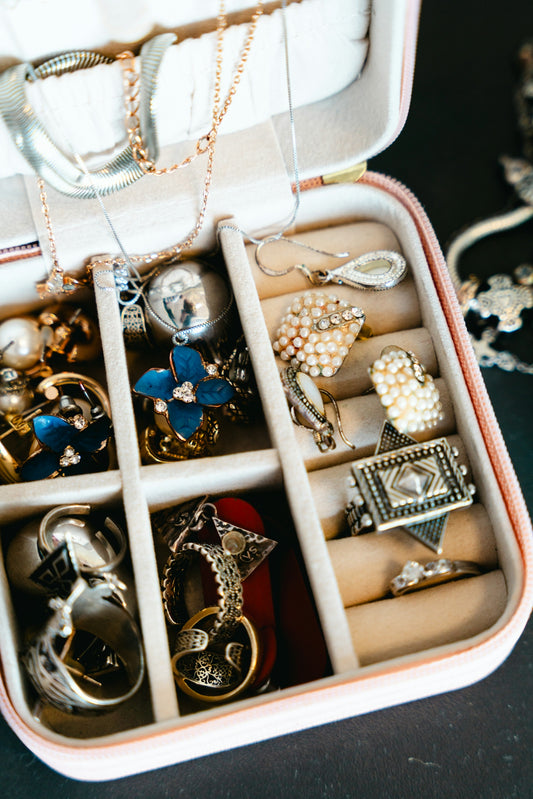 Jewelry box filled with necklaces, rings, and earrings.